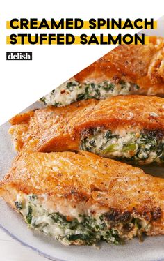 some food is on a white plate and has the words creamed spinach stuffed salmon