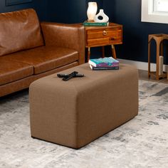 a living room with two brown leather couches and a coffee table in the corner