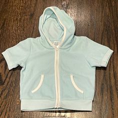 Uniqlo Short Sleeve Hoodie Size 12-18m. Zip Close. New With Tags. Unisex Cotton Hooded Sweatshirt For Playwear, Hooded Cotton Sweatshirt For Playwear, Blue Winter Sweatshirt For Playtime, Sporty Hooded Hoodie For Playtime, Cotton Hoodie With Adjustable Hood For Playtime, Cotton Hooded Hoodie For Playwear, Casual Hoodie Top For Playtime, Cotton Playtime Hoodie Outerwear, Cotton Hooded Hoodie For Playtime