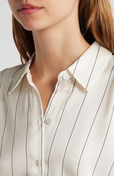 Pinstripes punctuate a creamy-hued button-up shirt that would look just right running the show from the C-suite. 27" length Front button closure Long sleeves with button cuffs 100% polyester Dry clean Imported Pinstripe Collared Shirt For Work, Workwear Shirt With Vertical Stripes And Spread Collar, Elegant Shirt With Vertical Stripes For Daywear, Elegant White Tops With Vertical Stripes, Pinstripe Shirt With Placket For Work, Collared Shirt With Vertical Stripes For Work, Classic Top With Striped Collar For Daywear, Elegant Formal Tops With Striped Collar, Elegant Formal Top With Striped Collar