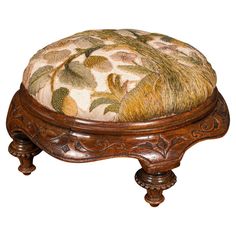 a wooden foot stool with a floral design on it