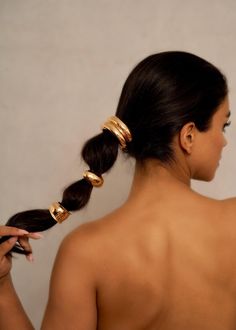 Elevate your ponytail with these 18K Gold Plated Hammered Arched Cuffs. These elegantly designed accessories combine hammered textures with a graceful arch, adding a touch of sophistication to your look.    Measurements: SINGLE SMALL Cuff *  1.1 cm wide & 4.7 cm long     Measurements: SINGLE LARGE Cuff * 2 cm wide & 7.1 cm long    Measurements: DOUBLE Cuff * 3.3 cm wide & 7.3 cm long   Measurements: Chunky Cuff * 3.2 cm wide & 6.8 cm long    Product Details * Material:18k Gold Plated (Gold Only) Hairstyles With Gold Accessories, Hair Cuff, Long Ponytail, Hair Cuffs, Hair Jewels, Gold Hair Accessories, Pearl Cuff, Hair Wraps, Christmas Hair