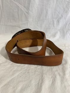 "Measurements in inches: Long: 46\" Deep: 1\"7 First perforation from buckle is 34\" and 40\" on the last Buckle measurements W: 5 H: 3\"2 Condition: -Good Pre-owned condition for its age -Buckle shows normal sings or wear from use -Belt is clean Shipping: -All purchases are sent within 1-2 business days -I send all the domestic purchases via USPS Priority mail and include a tracking number (emailed upon request). If you need an extra service please request it once you purchase your item -For in Classic Antique Belt Buckles For Ranch, Classic Leather Belt Buckles For Rodeo, Western Leather Belts For Formal Occasions, Western Style Leather Belt For Formal Wear, Classic Brown Belt For Ranch, Brown Leather Rodeo Belt, Brown Leather Belt For Rodeo, Leather Belt Buckles For Rodeo, Leather Belts With Antique Buckle For Rodeo