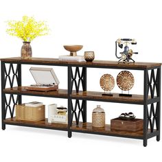 a shelf with some vases and other items on it's shelves next to a yellow flower