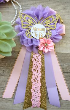 a close up of a ribbon with flowers on it and a name tag attached to it