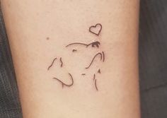 a tattoo on the arm of a woman with a dog's head and heart