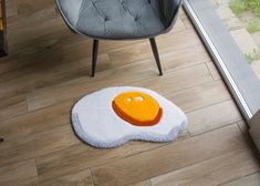 an egg rug is on the floor next to a chair