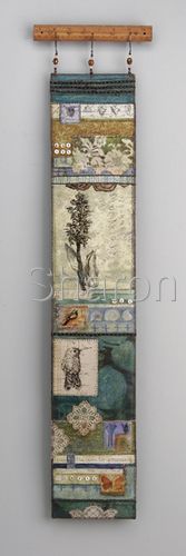 a wall hanging on the side of a gray wall next to a white wall and a wooden rail