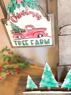 a christmas tree farm sign hanging from the side of a wooden building with trees painted on it