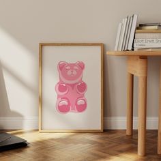 a pink teddy bear sitting on top of a wooden floor