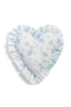 a heart shaped pillow with blue flowers on it