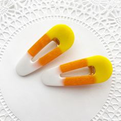 Add a sweet touch of Halloween spirit to your hair with these adorable Candy Corn Hair Clips! Perfectly capturing the iconic colors of candy corn, these clips feature a vibrant blend of yellow, orange, and white in a smooth, glossy finish. The classic barrette shape makes them easy to wear and ideal for adding a playful, festive vibe to any hairstyle. Whether you're dressing up for Halloween or simply want to embrace the fall season, these clips are a fun and stylish way to do it. They also make Candy Hair Accessories, Halfling Bard, Candy Corn Hair, Halloween Hair Accessories, Candy Hair, Halloween Accessories Hair, White Candy, Halloween Hair, Halloween Spirit