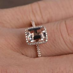 A perfect handmade 1.75 Carat Peach Pink Morganite (7x5mm Emerald Cut Morganite) Diamond Moissanite Halo Engagement Ring with 18k Gold Plating in 925 Silver with Rose Gold Plating. This engagement ring is pure classics to those with a modern twist. The iconic engagement ring mounts always heros the centre morganite, lifting it up to the light allowing it to sparkle with maximum fire, life and brilliance. We delicately handcraft the ring setting to honour our promise of brilliance and beauty as y Moissanite Halo Engagement Ring, Fire Life, Engagement Ring Mountings, Engagement Rings Sale, Moissanite Engagement Ring Halo, Morganite Diamond, Silver Anniversary, Pink Morganite, Ring Setting