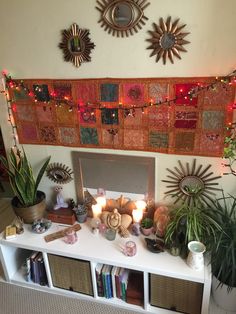 a living room filled with lots of plants and decorations on top of a white table