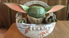 a star wars yoda in a basket on a table