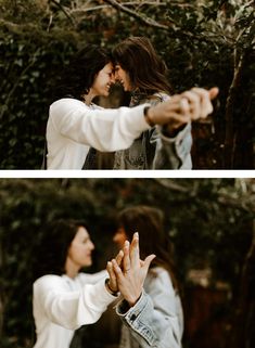 two people standing next to each other in front of trees and one person holding his hand out