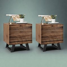 two wooden nightstands side by side with plants on top and one in the middle