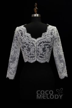 a white lace jacket on a mannequin dummy with the words coco melody written below it