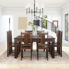 a dining room table with chairs and a vase on top of it in front of a staircase