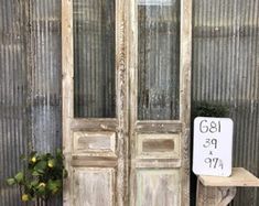 an old wooden door with a sign on it