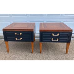 pair of nightstand tables with brass pulls in black and cherry wood, side by side