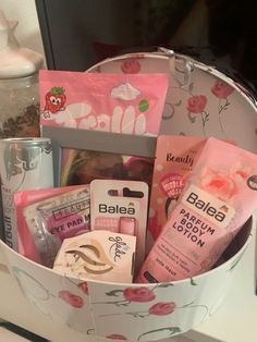 a basket filled with lots of different types of cosmetics and personal care items on top of a counter