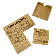 two wooden coasters with the words pennsylvania on them and a map in front of them