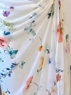 Fancy a dress that marries the freshness of a spring morning with the elegance of an evening soiree? This floral fantasy maxi dress is a canvas of white adorned with bursts of vibrant blooms, perfect for the lady with a love for nature and sophistication. The gentle off-shoulder neckline is both flattering and alluring, leading to a form-fitting bodice that cascades into a flowing skirt. The subtle ruching at the waist adds texture and defines your silhouette, making this the ideal dress for pro Elegant Fitted Off-shoulder Floral Dress, Fitted Off-shoulder Embroidered Dress With Floral Design, Flowy Floral Print Off-shoulder Dress, Off-shoulder Floral Embroidered Summer Dress, Luxury Off-shoulder Floral Print Dress, Sunflower Dress, Classic Romance, Off Shoulder Gown, Floral Gown