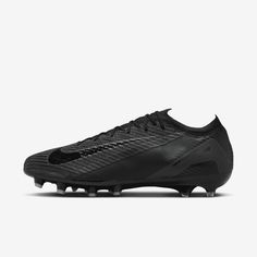 a black soccer shoe on a white background