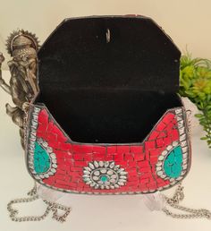 This bag is a statement piece of jewelry with mosaictiles stones of Corals, Turquoise, Silver & Brass. Boho Clutch metal bag-purse that won't stop bringing you complements and turn heads around. Handmade from Brass and inlaid with stones, one by one, makes every purse one of a kind ethnic bohemian clutch purse, tribal style, vintage look evening bag. Made in the Himalayas, inside filled with velvet, to complete the ethnic but elegant look for each bag. You can hang it on your shoulder or use Square Evening Bag With Phone Holder As Gift, Crossbody Box Bag As Gift, Gift Crossbody Box Bag For Mobile Phones, Square Clutch With Removable Pouch As Gift, Red Rectangular Shoulder Bag For Gift, Multicolor Mobile Phone Bag As Gift, Portable Clutch Bags For Gifts, Portable Clutch Bags As A Gift, Handheld Mobile Phone Box Bag As Gift