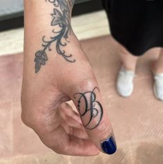 a woman's hand with a tattoo on it