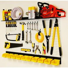 a pegboard with tools hanging on it and some yellow bins next to it