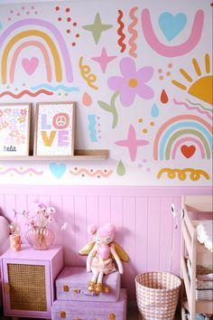 a child's room decorated in pastel colors with rainbows and hearts on the wall