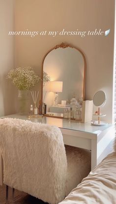 an image of a bedroom with a vanity and mirror on the wall, as well as a bed