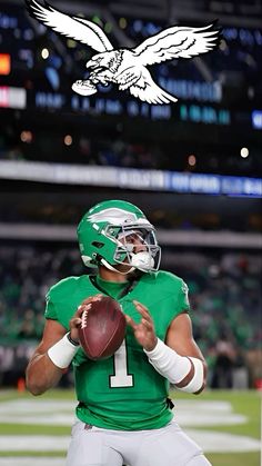 a football player holding a ball and an eagle on the sideline in front of him