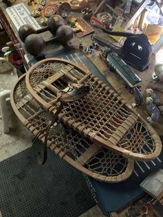 a wooden boat sitting on top of a table next to other items in a room