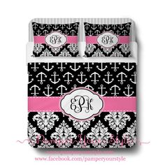 black and pink bedding with an anchor monogrammed on the bottom, along with white damask