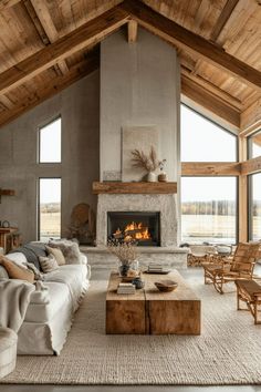 a living room filled with furniture and a fire place in the middle of a room