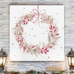 a christmas wreath is hanging on the wall next to a fireplace with candles and decorations