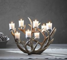 a candle holder made out of antlers and candles