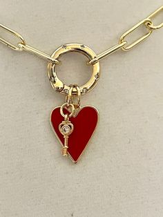 A gorgeous 18k gold plated, brass paperclip chain with a CZ spring lock carabiner. This holds a beautiful red heart enamel pendant and a gold and cz key charm. The spring lock carabiner features 7 small CZ stones on both sides. Heart and key charm necklace -Perfect Valentines Day gift  Easy to add more charms or just change out for another look. Approximate size Brass Chain link - 7mm x 17mm Approximate Measurement of the spring gate carabiner- 20mm Approximate size  Red Heart -20mm x 24mm Approximate size of Key charm 5mmx15mm The chain is Lead Safe and Nickel Safe, high Quality 18k gold plated Brass with several electroplating layers. Tips to keep your jewelry looking good. 1) Keep jewelry away from water and chemicals. 2) Remove during physical activities. 3) Store separately in a soft Luxury Heart Charm Chain Necklace With Heart Pendant, Cheap Gold Double Heart Charm Necklaces, Luxury Heart Shaped Charm Necklaces, Luxury Heart Charm Necklace, Luxury Heart Charm Necklace For Women, Luxury Heart Cut Charms Necklace, Luxury Gold Plated Heart Pendant Charm Necklaces, Cheap Heart Charm Chain Necklace For Valentine's Day, Luxury Heart Shape Charm Necklace