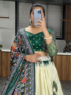 Elevate your ethnic wear collection with this beautiful off-white & green patola printed silk traditional lehenga choli. Crafted from high-quality dola silk material, this stunning ensemble features intricate patola and paithni printed work along with foil work (crush work) that adds a touch of elegance and sophistication. The off-white lehenga is paired with a green color dola silk choli and a matching dupatta, making it a perfect choice for weddings, festivals, or any special occasion.
Thi Green Traditional Wear With Ikat Print And Traditional Drape, Green Traditional Wear With Ikat Print Drape, Green Ikat Print Traditional Drape Wear, Green Traditional Wear With Ikat Print, Ikat Print Lehenga For Wedding And Festivals, Wedding Lehenga With Ikat Print For Festivals, White Ikat Print Traditional Wear For Diwali, Traditional Ikat Print Lehenga For Navratri, Green Ikat Print Dupatta Traditional Drape