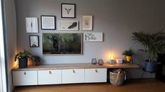 a living room filled with furniture and pictures on the wall