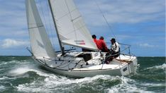 two men on a sailboat in the ocean