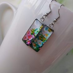 Vibrant Flowers Art Pattern Painting Handmade Glass Jewelry Hook Earrings Artistic bold statement earrings, a perfect gift and choice for any occasion. Ideal gift for an artist. Chic and Unique. Measures 25 mm in length and 10 mm in width. Comes with First Class Free shipping. Colors may vary due to monitor and lighting differences. Colorful Flower-shaped Jewelry For Gifts, Colorful Flower Shaped Jewelry Gift, Colorful Flower Shaped Jewelry For Gifts, Colorful Flower-shaped Jewelry Gift, Colorful Artsy Earrings For Gift, Hand Painted Rectangular Jewelry As Gift, Multicolor Rectangular Earrings As A Gift, Multicolor Rectangular Earrings For Gifts, Multicolor Dangle Earrings For Mother's Day