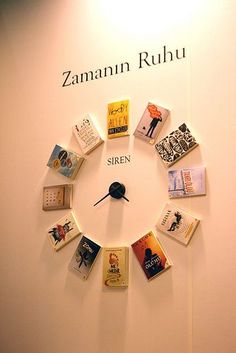 a clock made out of books and magnets with the words zamann rubu on it