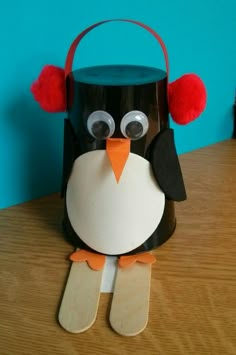 a paper bag with a penguin on it's head sitting on top of a table