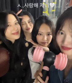 three girls are posing for the camera while holding dumbbells