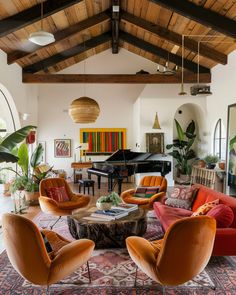 a living room filled with lots of furniture and a piano in the backround