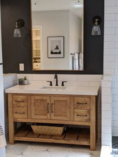 a bathroom vanity with two sinks and a large mirror over the sink in front of it